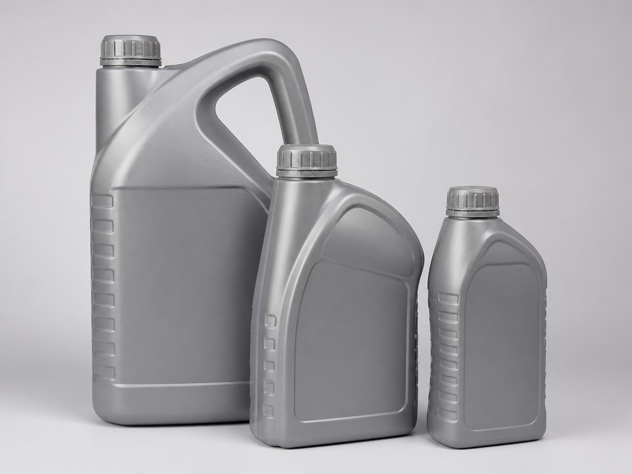 Unbranded automotive engine oil bottles on a light background